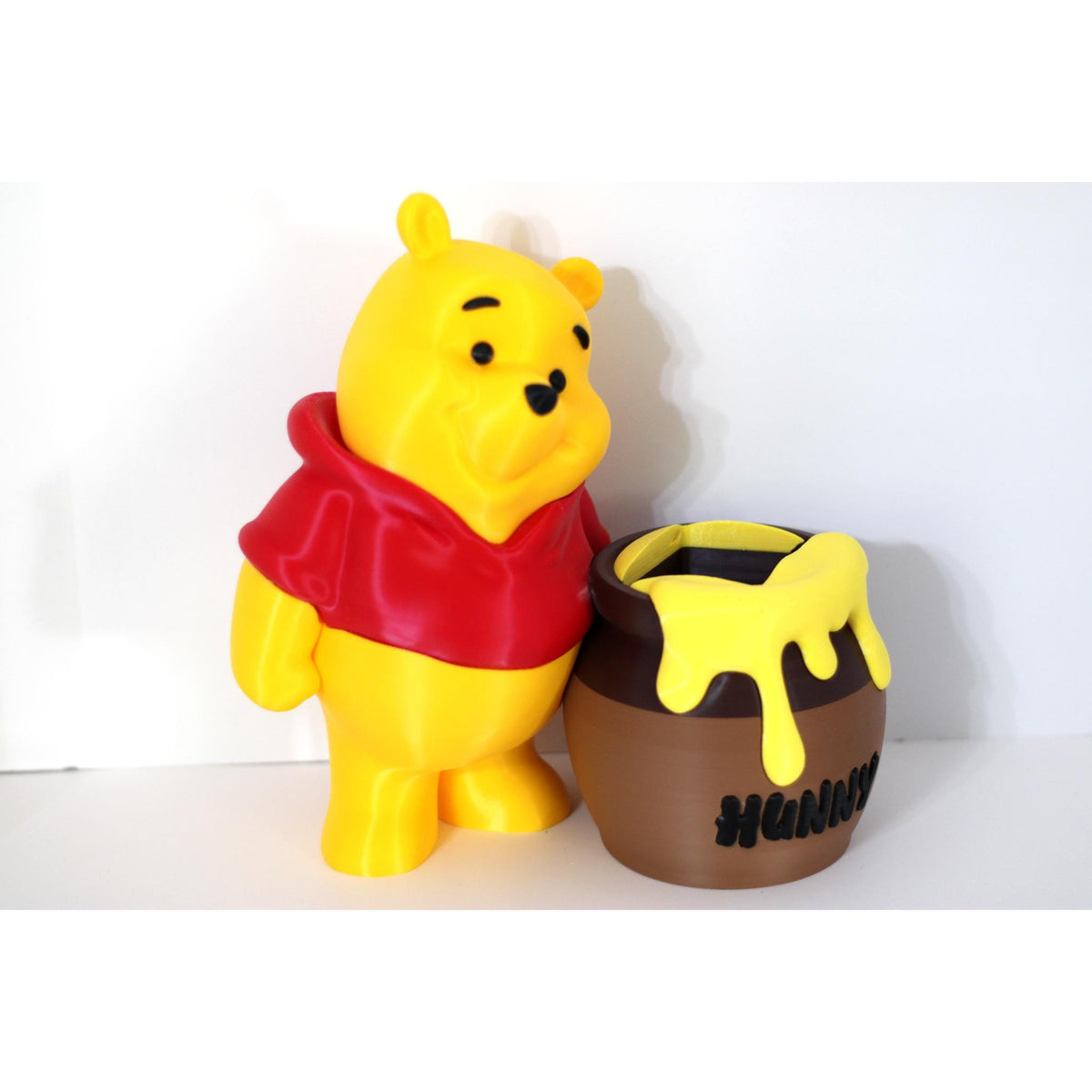 Bear figure shown beside the pot