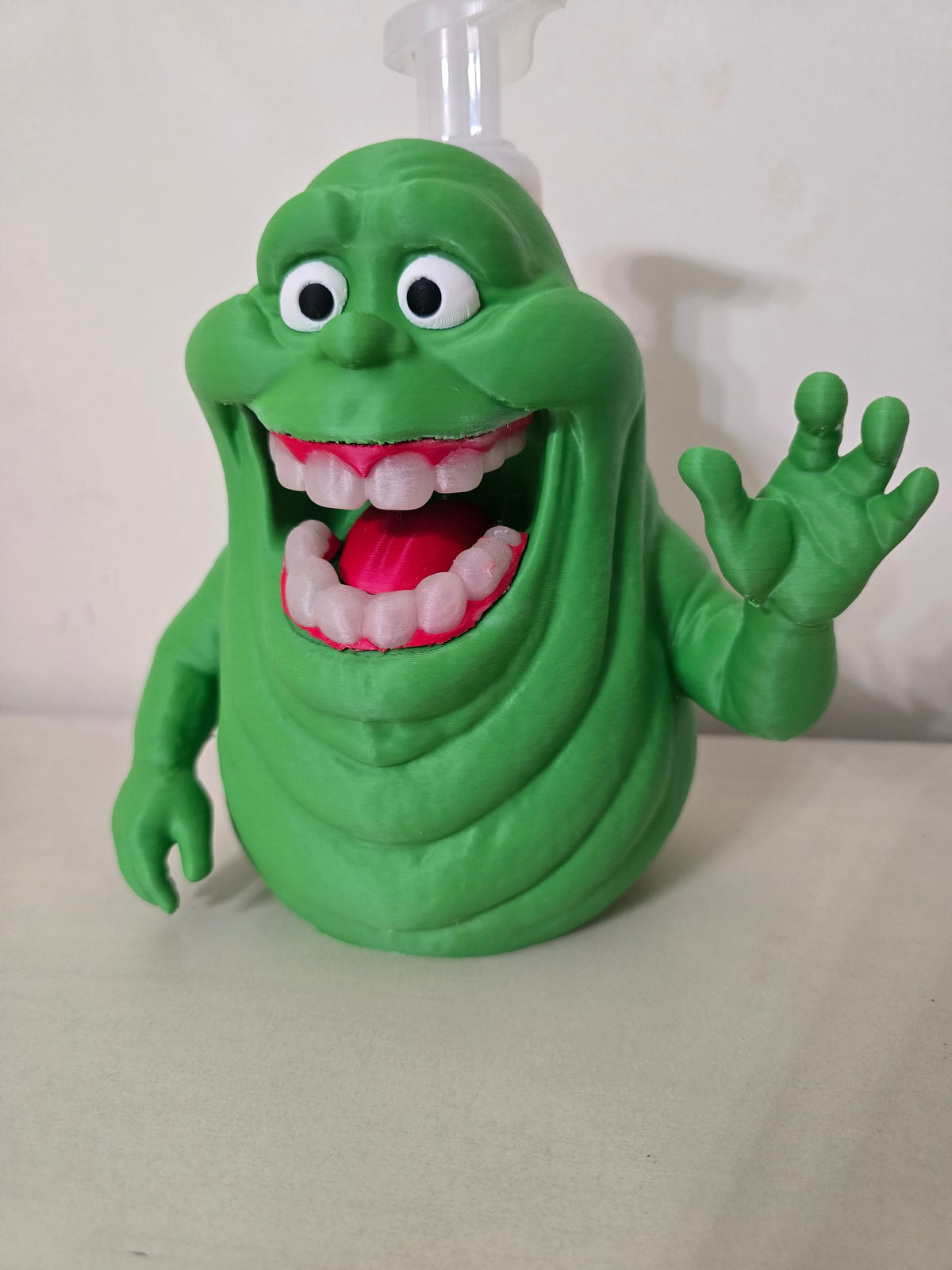 Green ghost soap dispenser holder with a Bath & Body Works pump