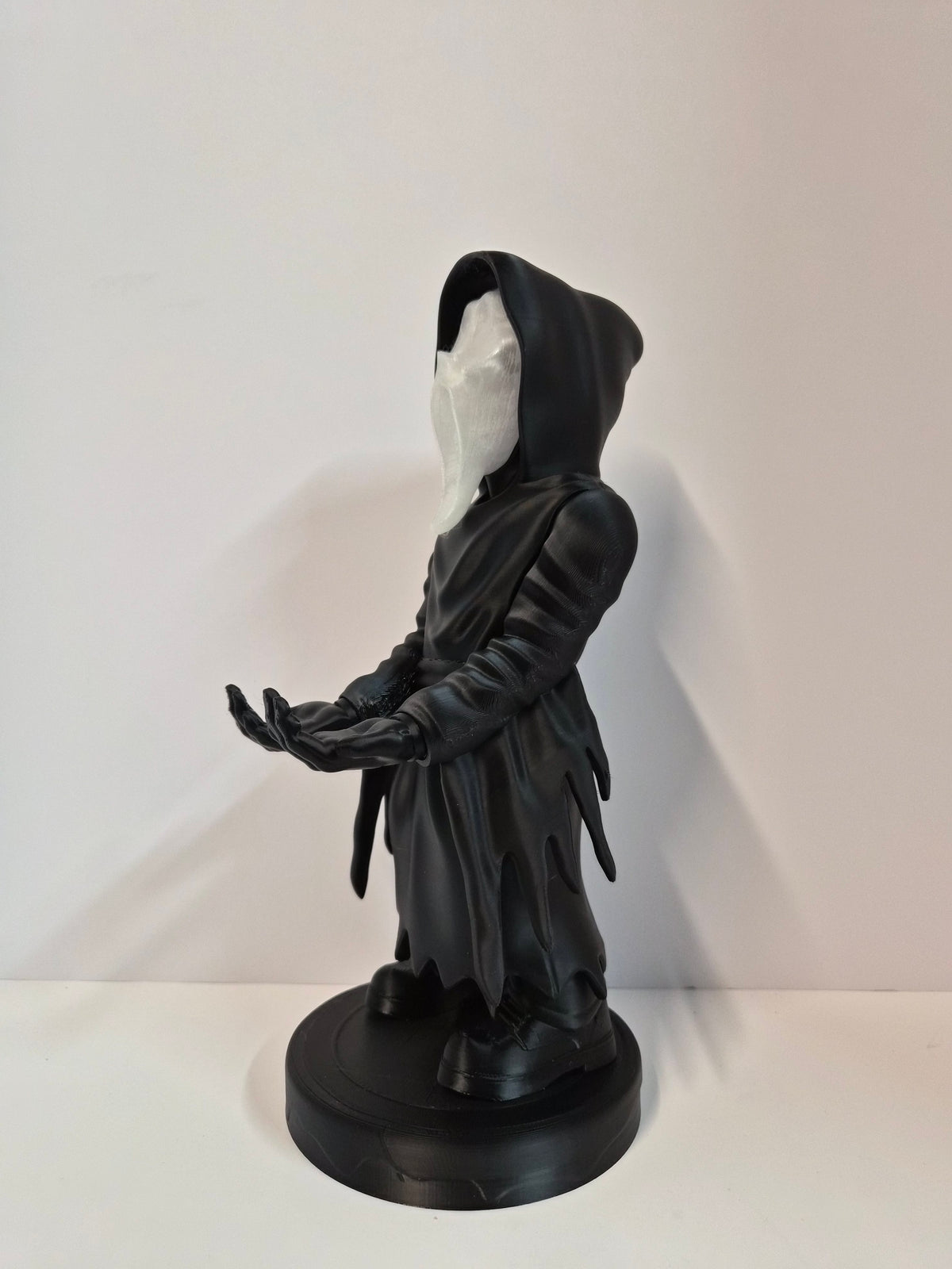 Phantom holder with the glowing face lit in the dark