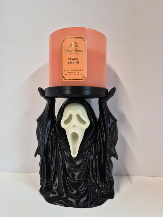 Hooded phantom candle holder holding a jar candle, glow-in-the-dark face, front view